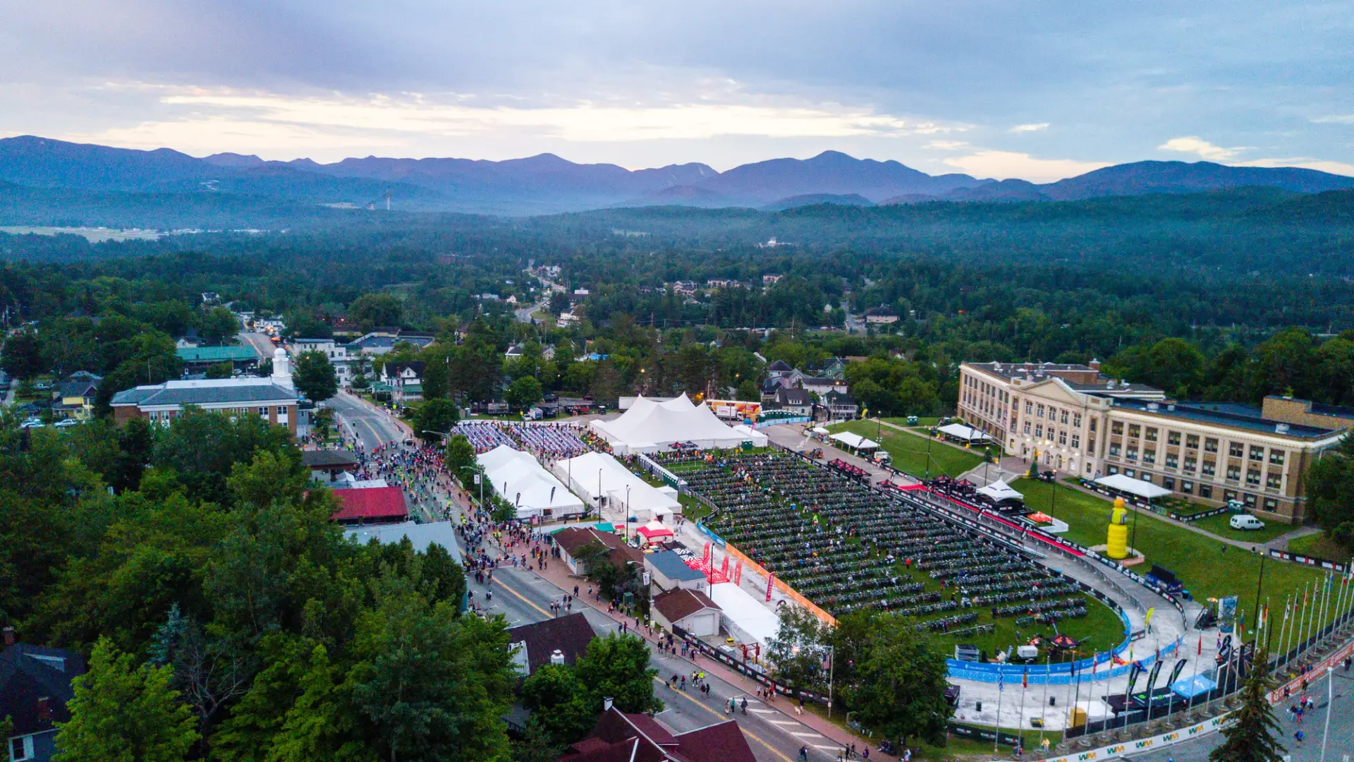 An overhead view of the Ironman race on a large field in the center of town. 