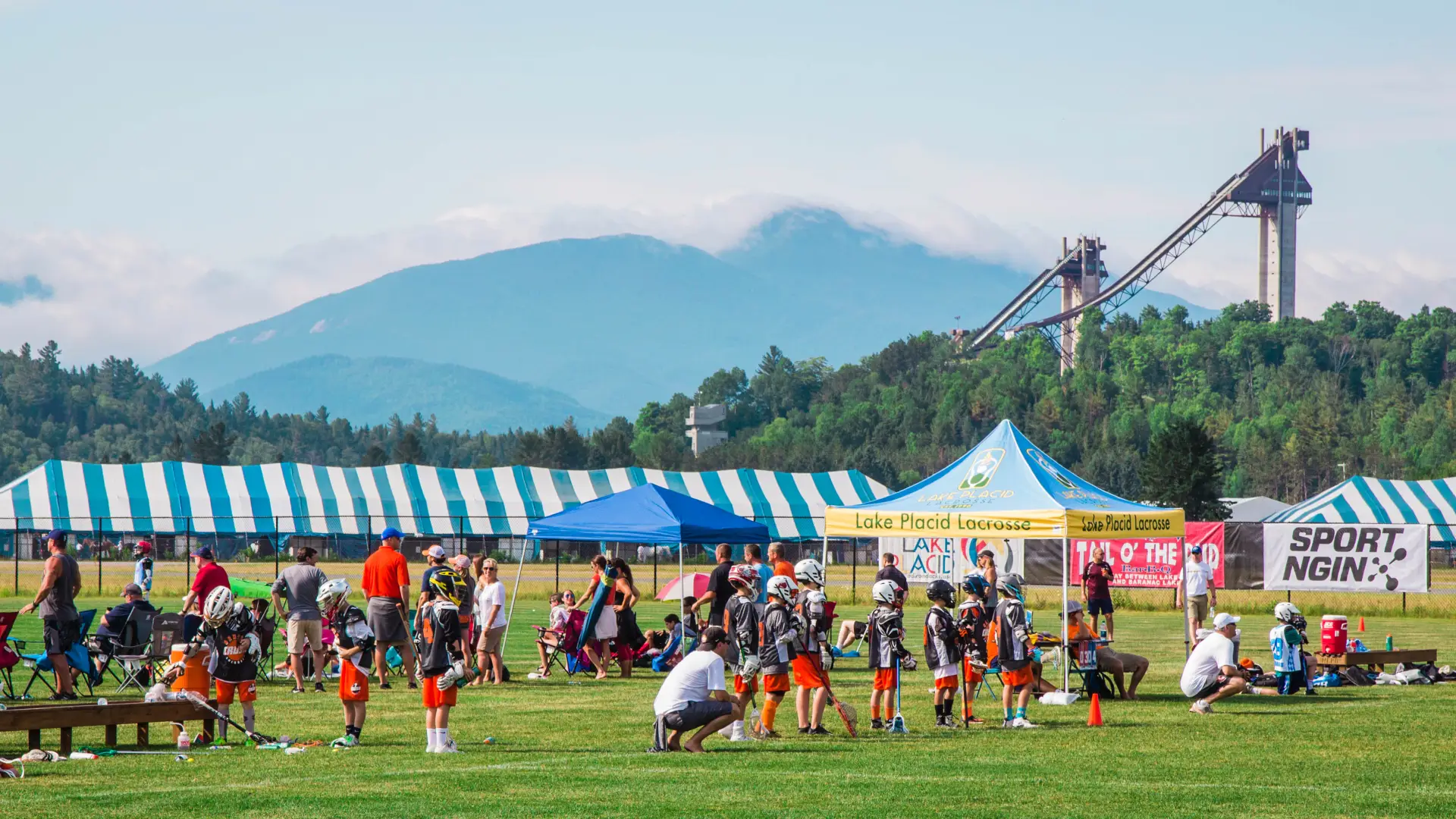 The Olympic ski jumps are seen in the background from a lacrosse tournament