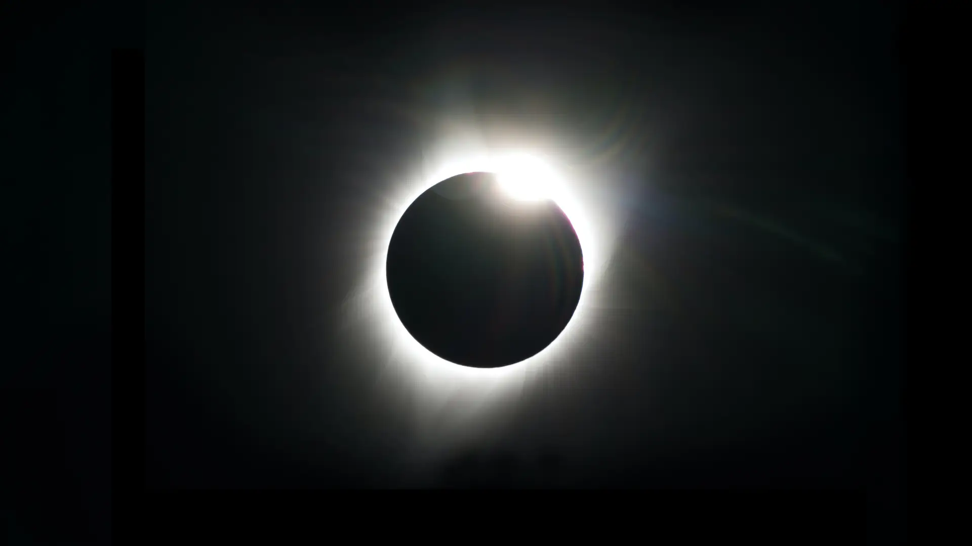 A black sky shows a total solar eclipse: a ring of white light surrounding a black disk, which is the moon