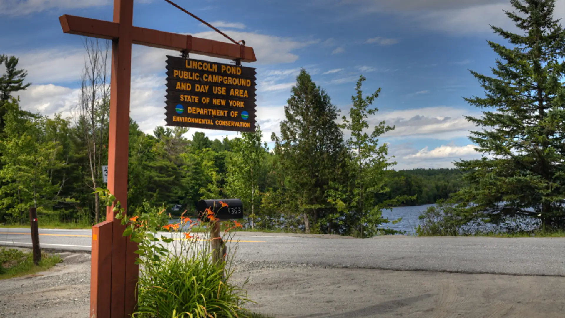 A yellow and brown sign marking a campground.