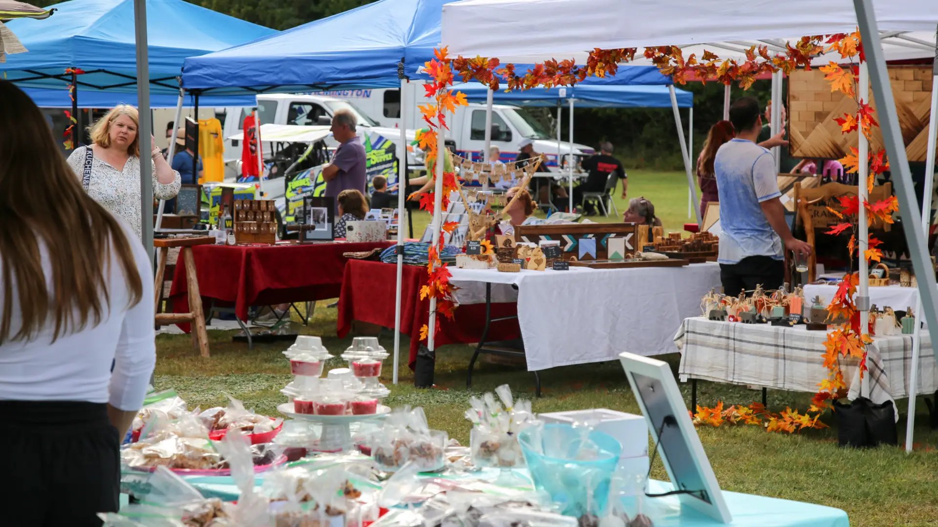 View of fall festival vendor tents seen through another vendor's tent