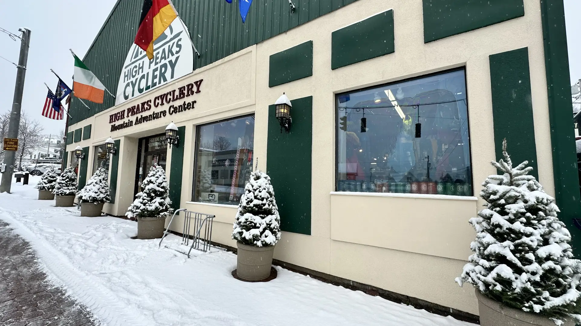 The front of High Peaks Cyclery covered in freshly fallen snow