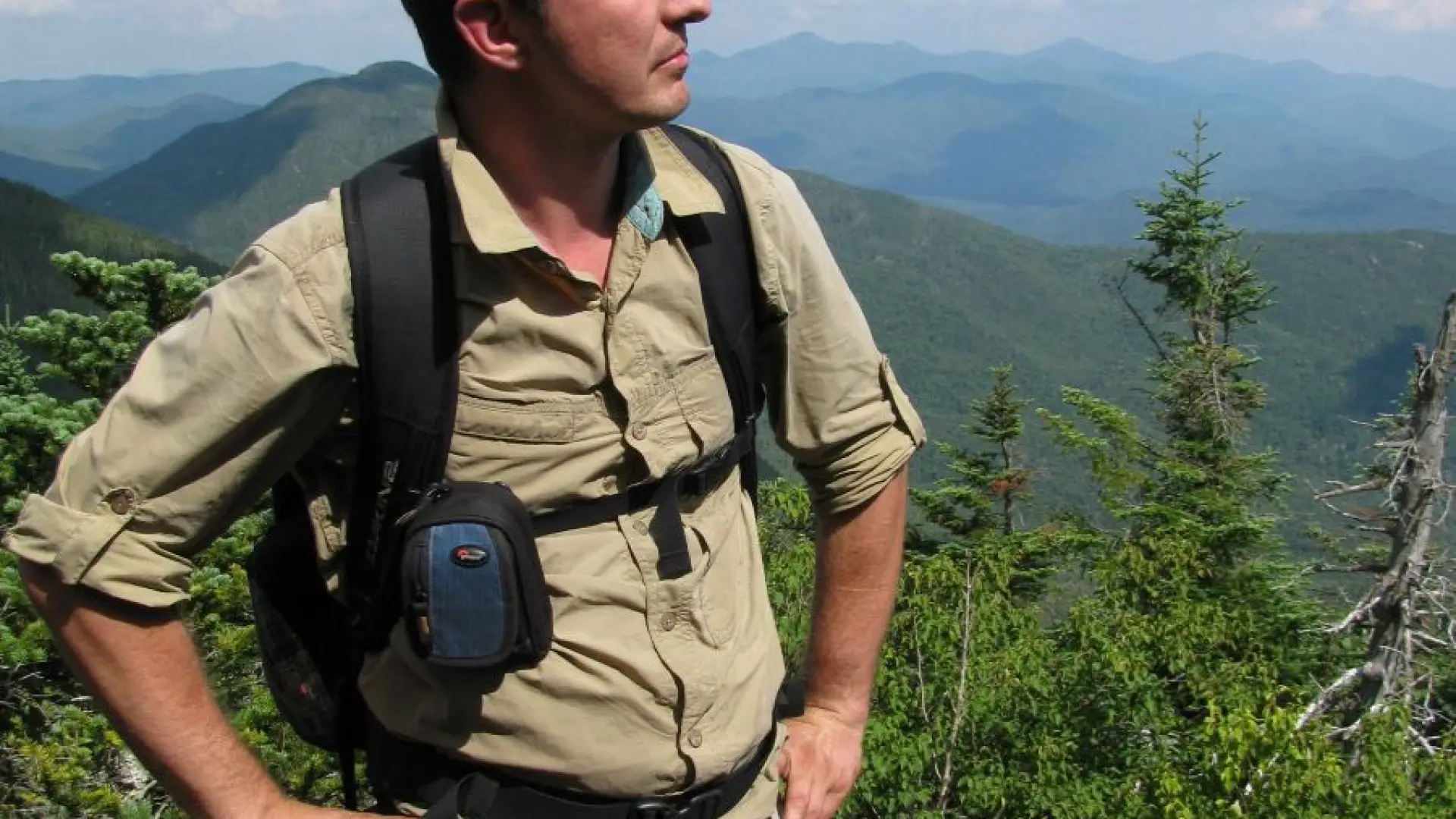 A man in beige clothes hiking in upstate ny
