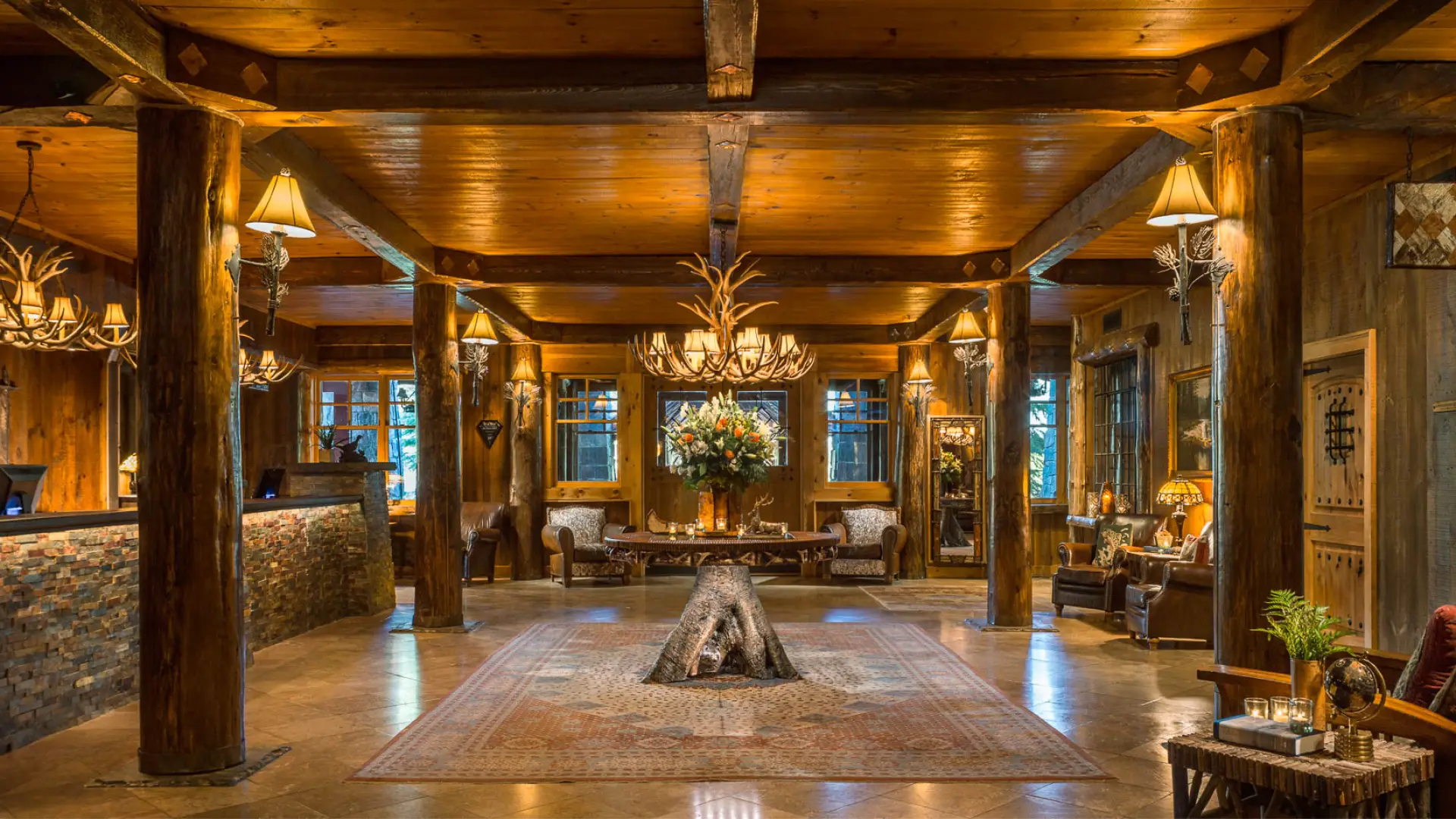 Lobby with wooden beams and marble floor.