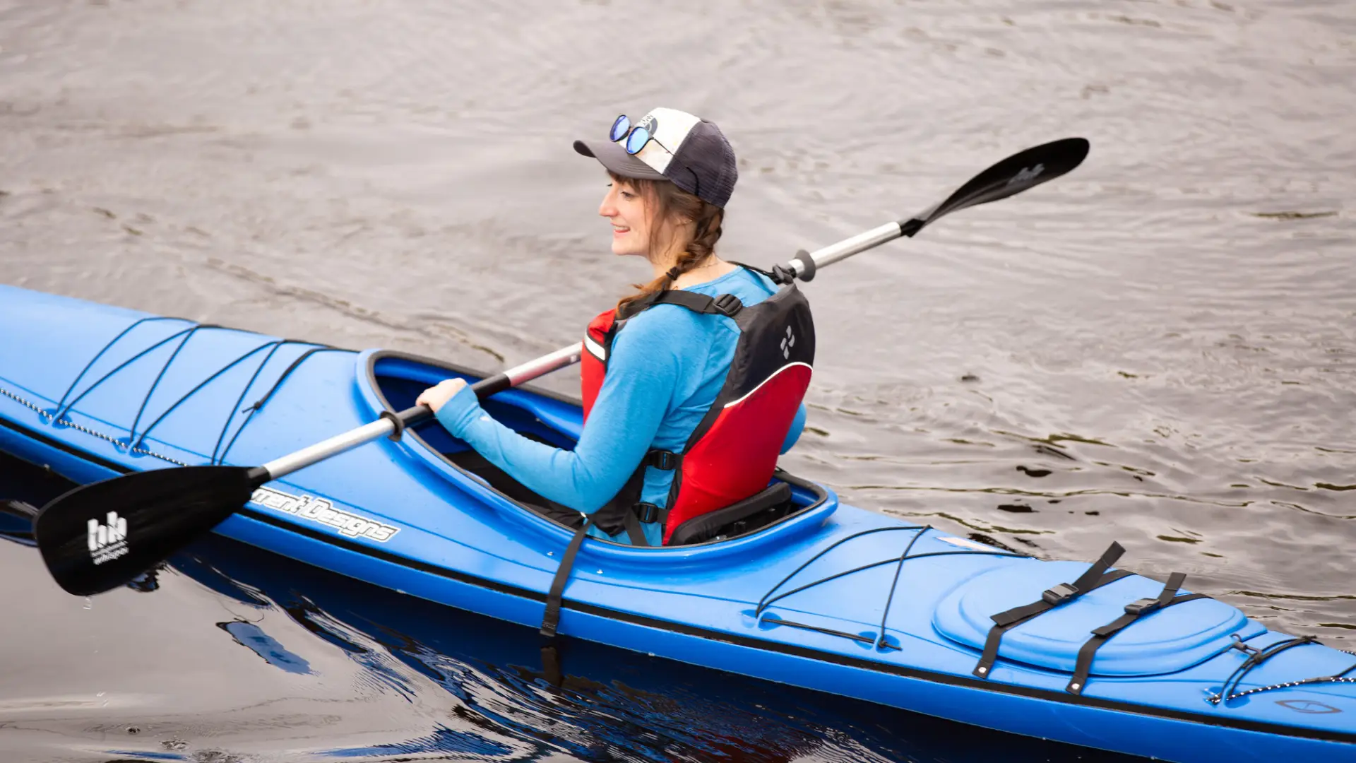 A woman paddles in a kayak.