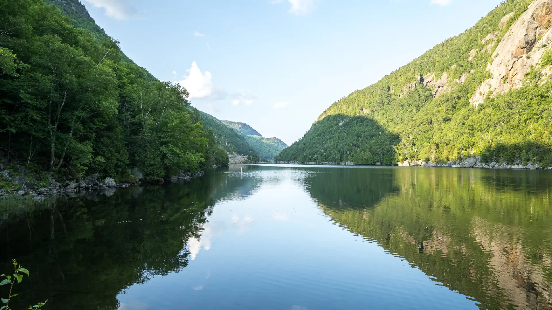 A lake mirroring the mountains surrounding it