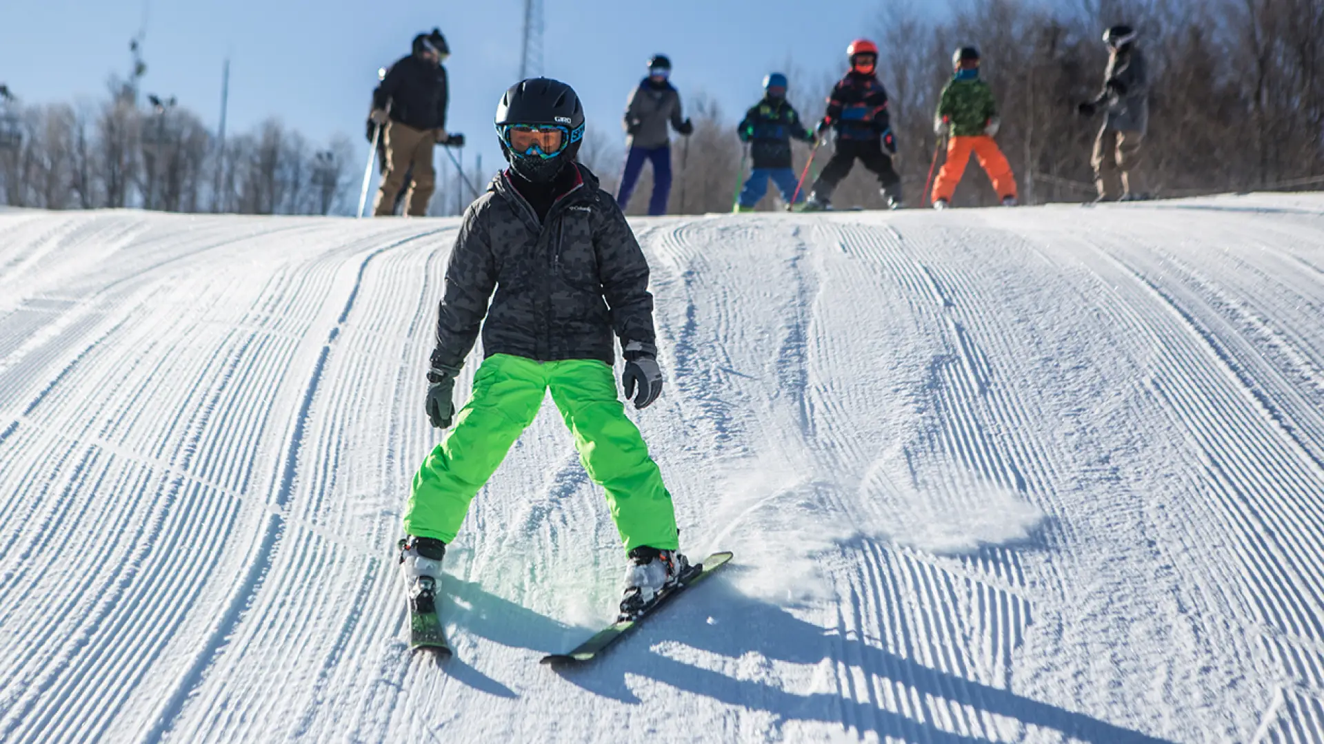 A young kid skiing down the slope at Mt Pisgah