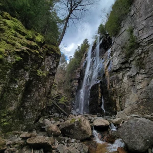 A large waterfall in a narrow granite canyon