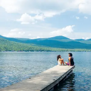 A mother and daughter on a dock in Lake Placid.