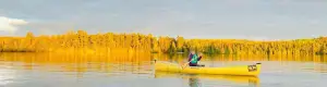 A woman paddling a canoe.