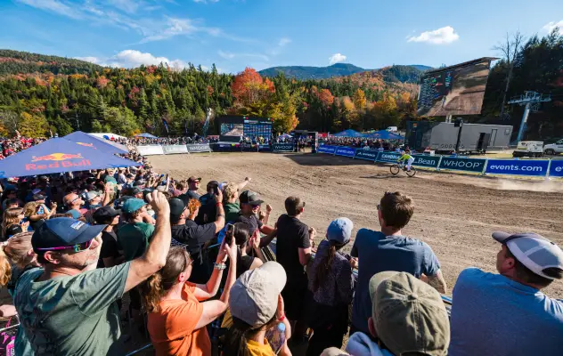 Spectators gathered at finish corral of the 2025 UCI Mountain Bike Downhill World Cup at Whiteface as rider finishes