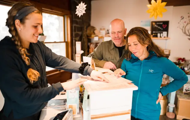 A couple standing at information desk at a hotel in Lake Placid.