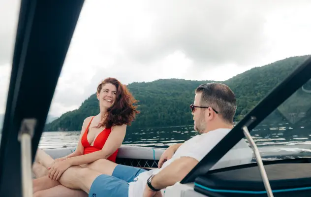 A man and woman lounge on a boat.