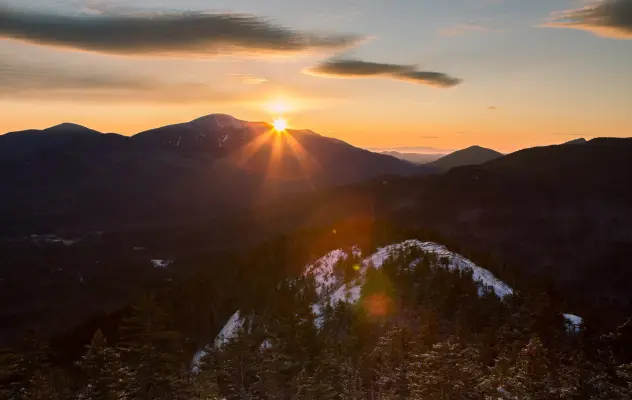The sun setting over mountain vistas in the winter.