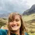 A selfie of a woman with a scenic background.