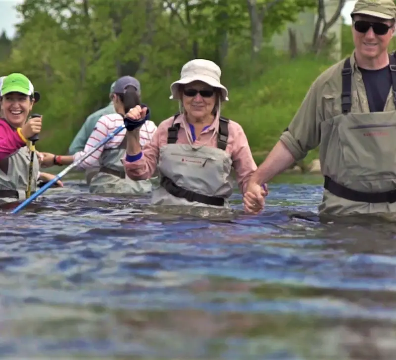 Group wading through river