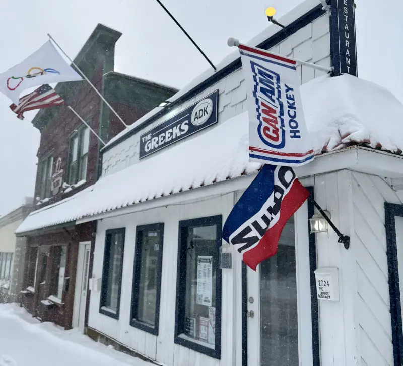 The exterior of the Greeks ADK blanketed in fresh snow