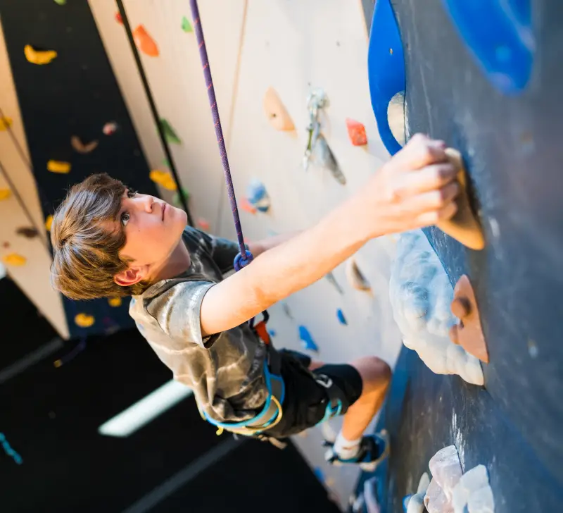 Child climbs wall at Rock Climbing Center