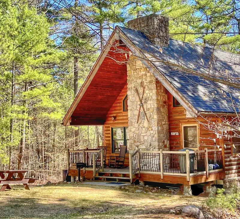 Cabin with stone fireplace, deck, and picnic table