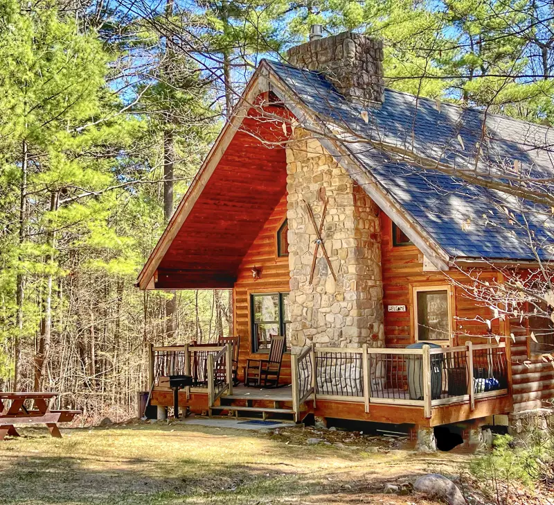 Cabin with stone fireplace, deck, and picnic table