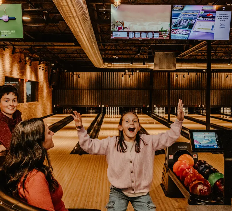 A young family is very excited to bowl.  Photo Credit to A. Kelly.
