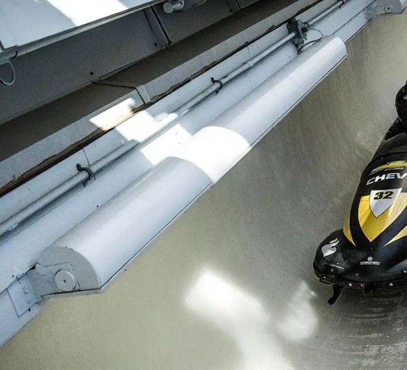 A group of four ride the Lake Placid bobsled experience