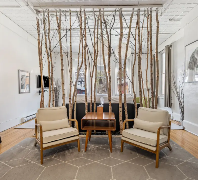 A beautiful white birch divider is the focal point of this lounge space at The Haus.