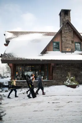 A family walks to a lodge. 