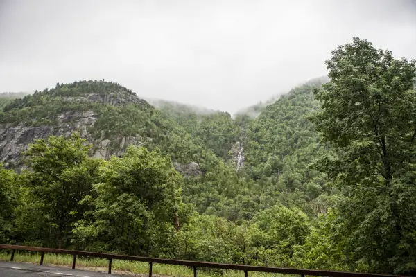 A high waterfall seen from the road.