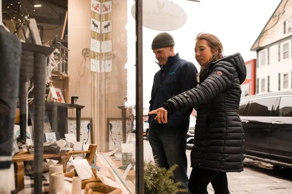 Two people window shopping in Lake Placid on Main Street.