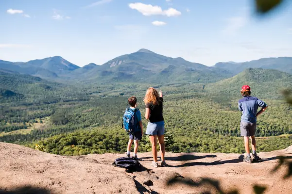 A family of hikers on top of a bare rock summit.