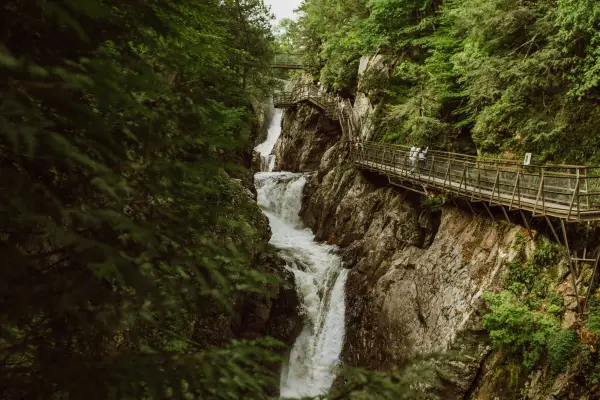 A narrow flume below an elevated boardwalk