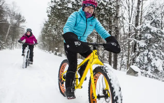 Two people fat tire biking on the Whiteface Veterans' Memorial Highway.