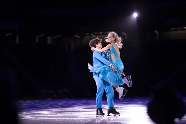 Two figure skaters dance in a competition on the ice. 