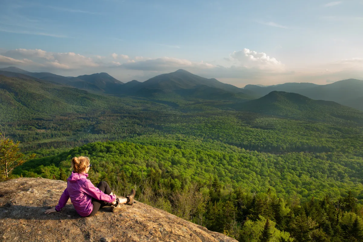 A woman on the summit of Mt Van Hoevenberg