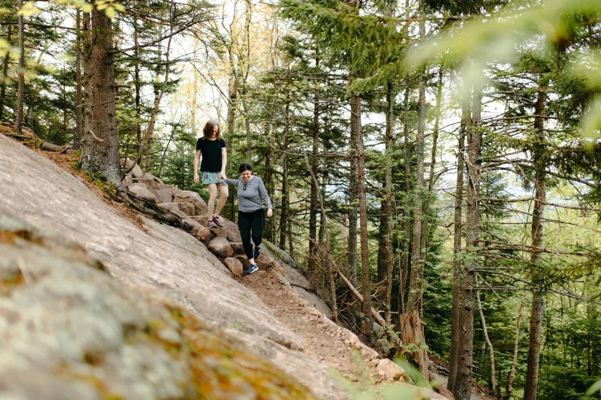 Two hikers skirting a cliff on Cobble Hill.
