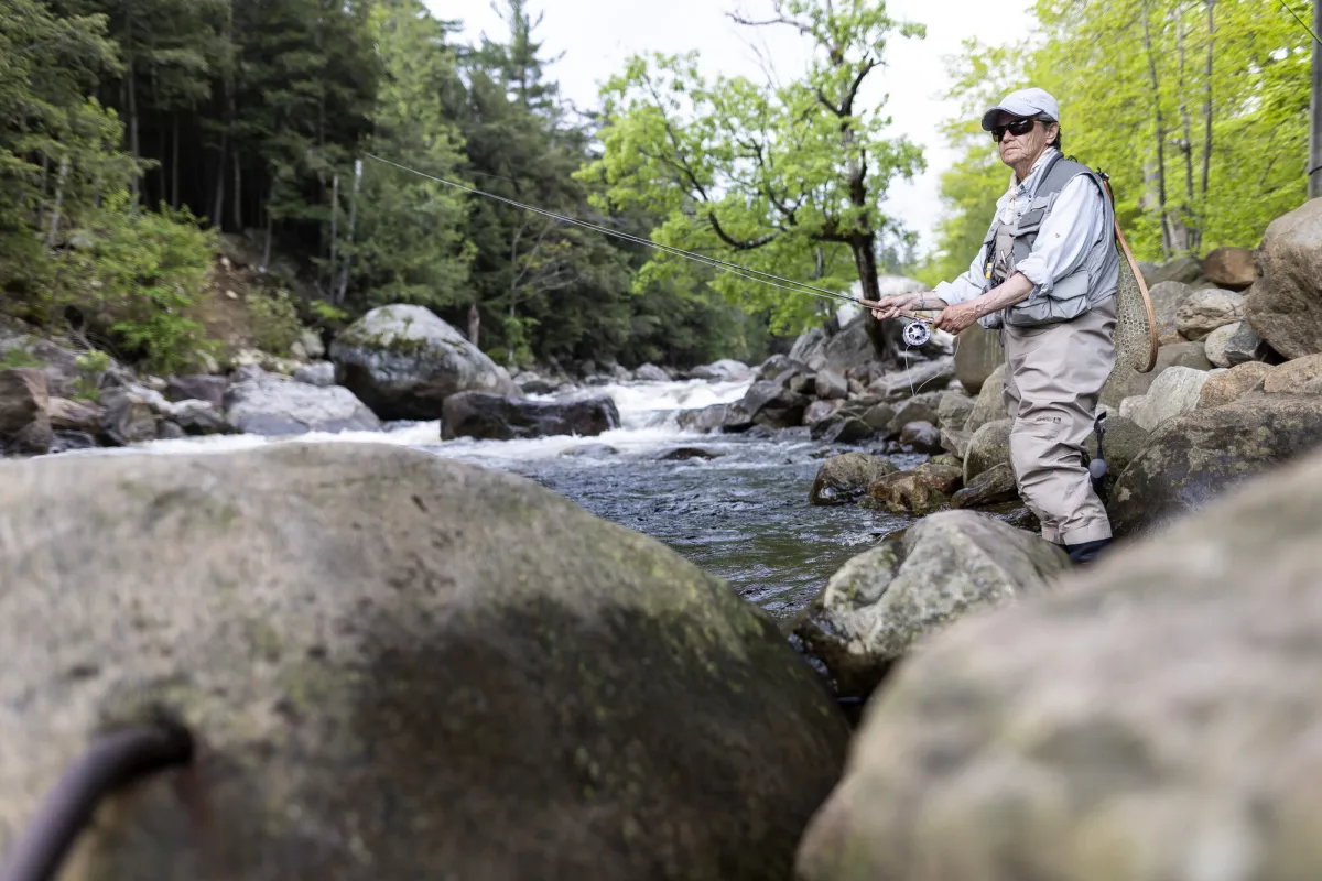 A fisher casting in the water.