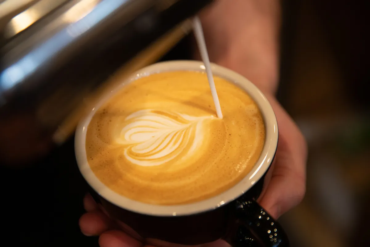 Coffee cup with a heart cream design.