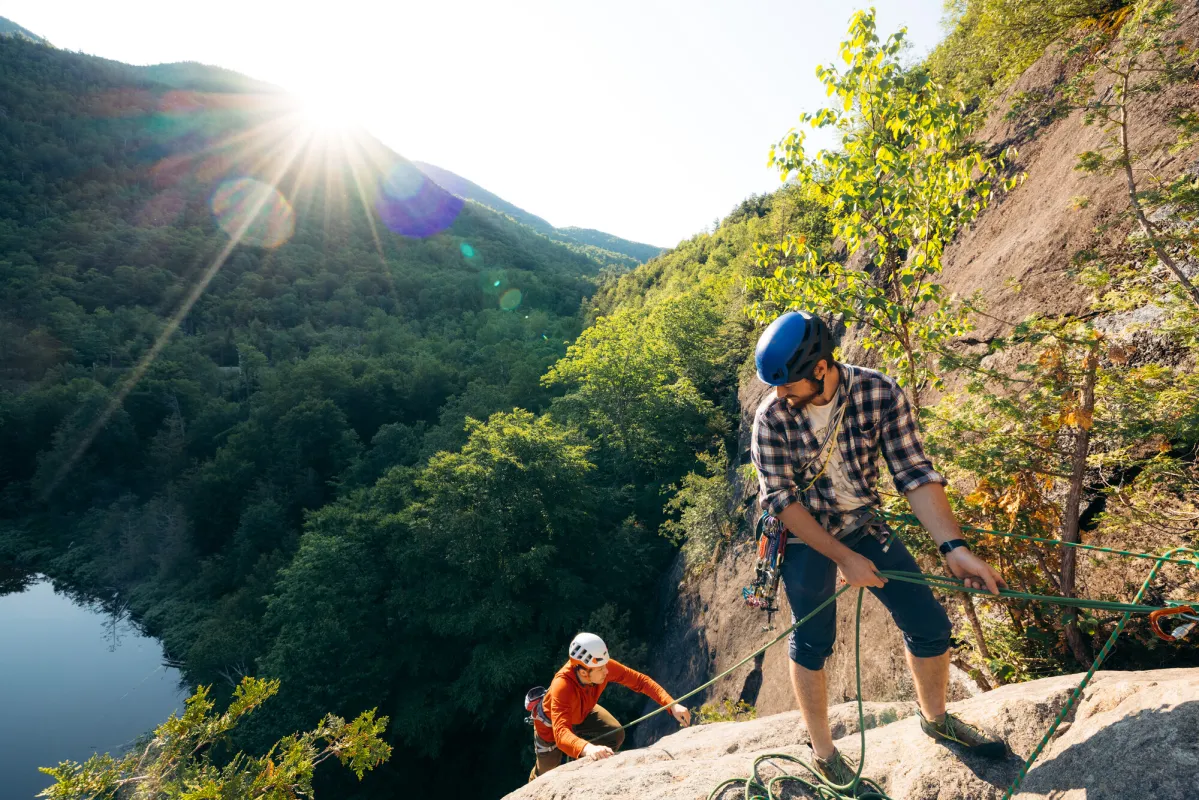 A climber belays his partner up a slab