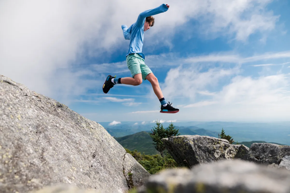 A person jumping from a rock.