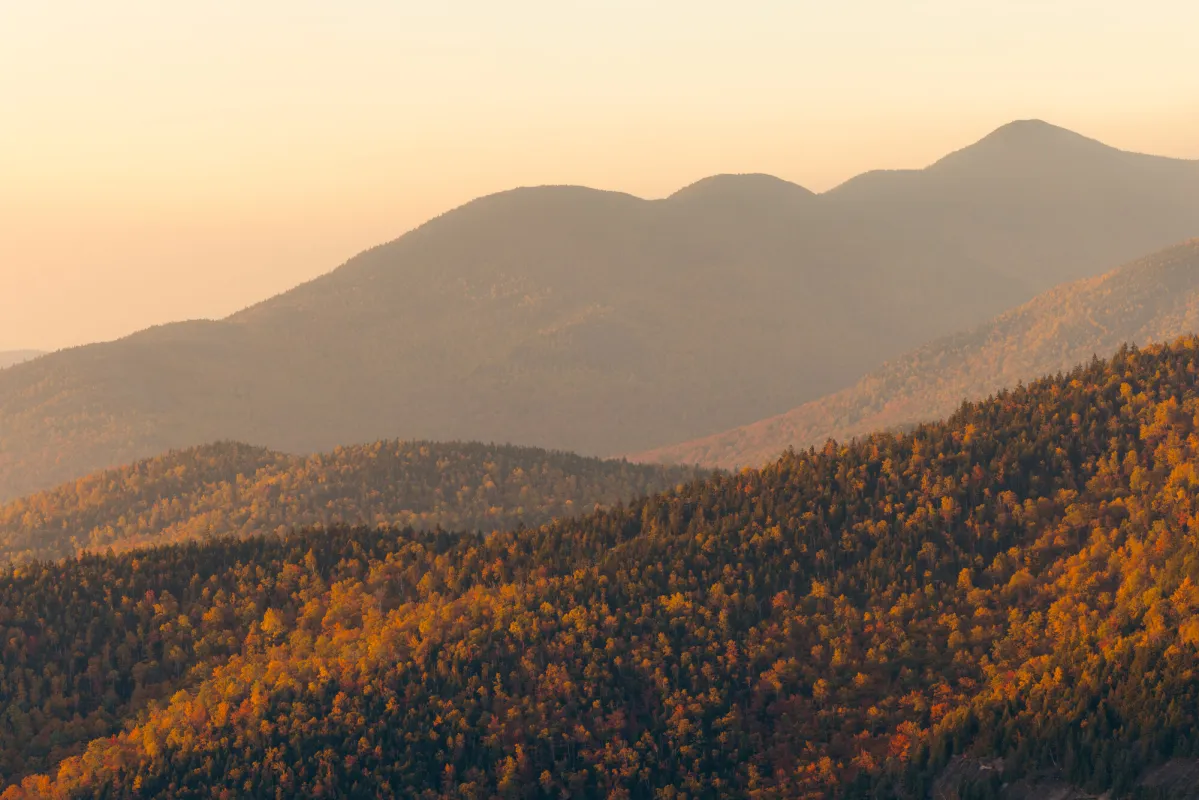 A hazy fall view of tall mountains