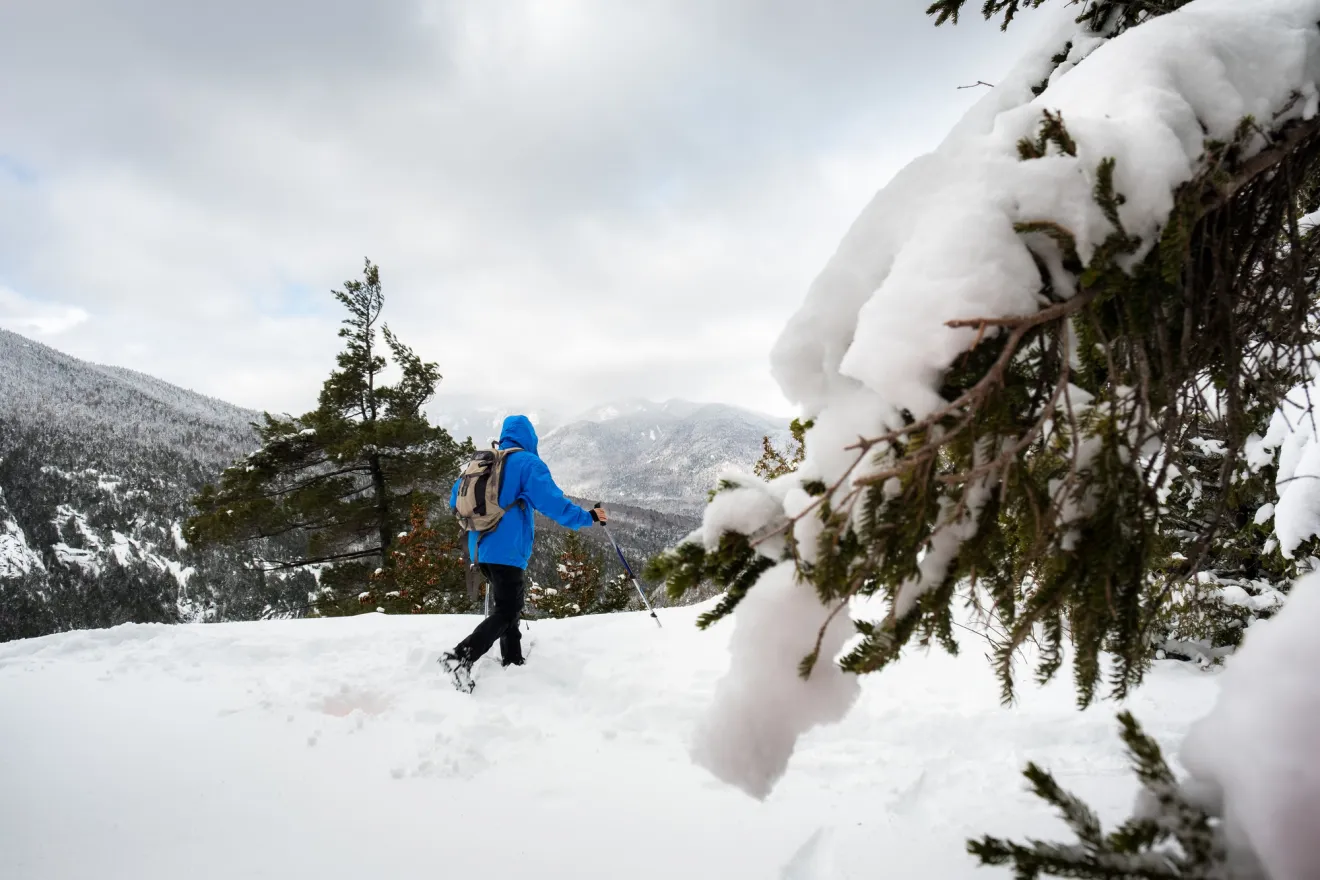 A hiker on a winter trail in the mountains