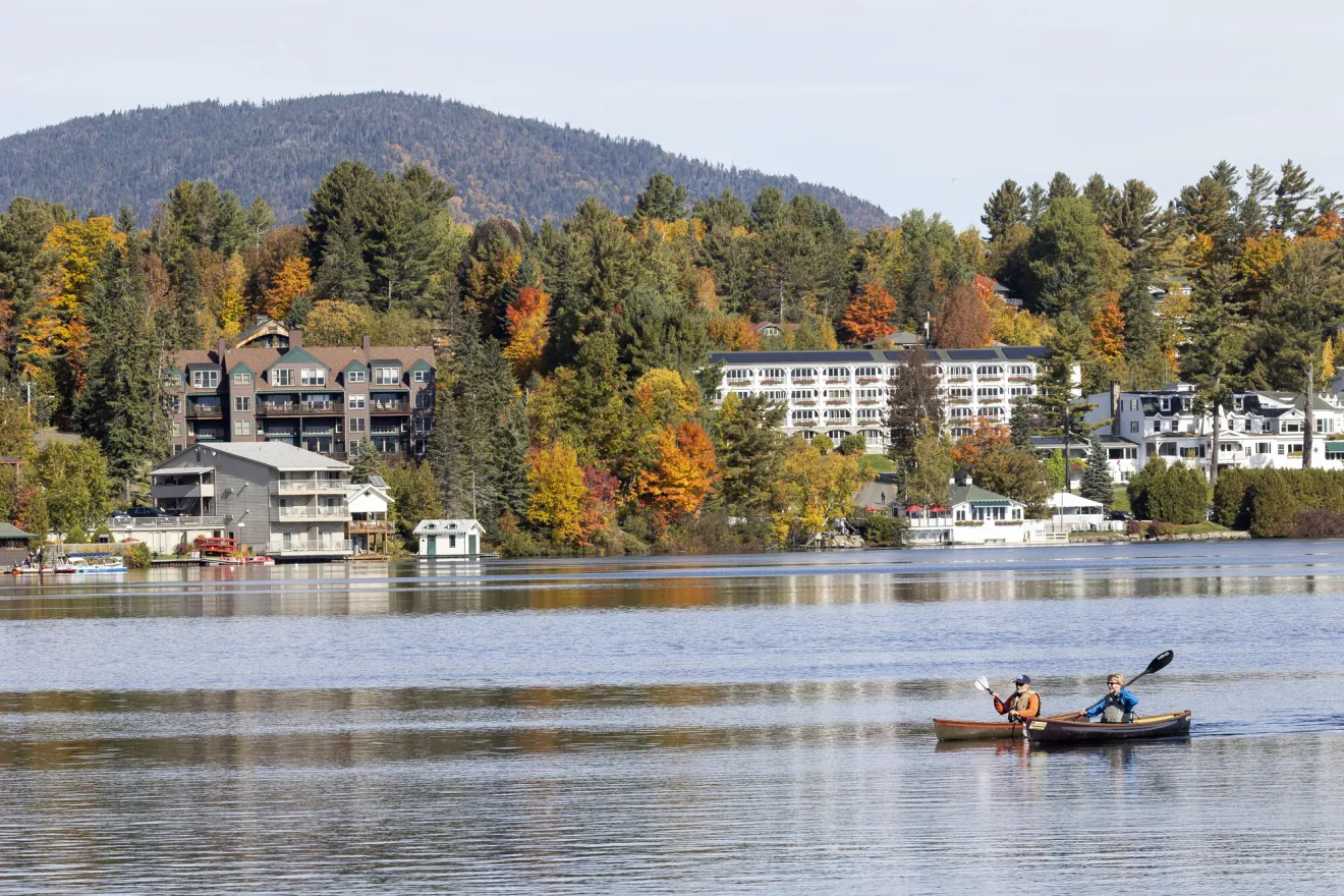 Two people canoeing on Mirror Lake in Lake Placid.