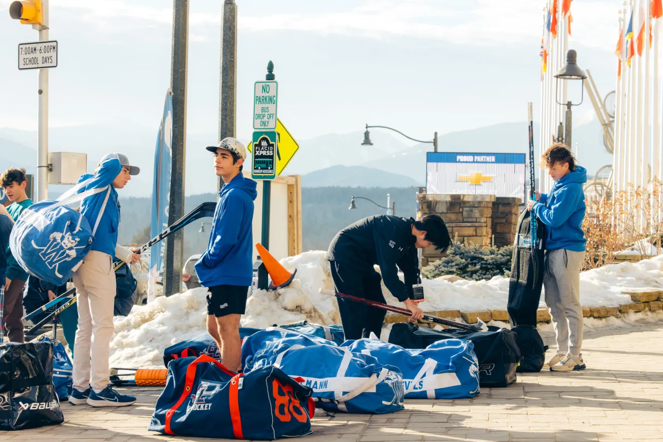 A hockey team prepares on a driveway. 