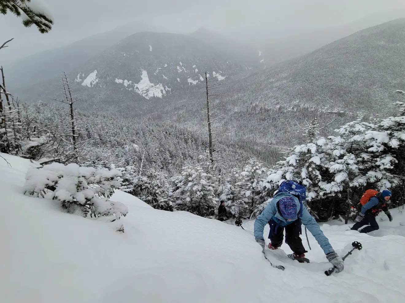 A winter hiker going up a steep slope