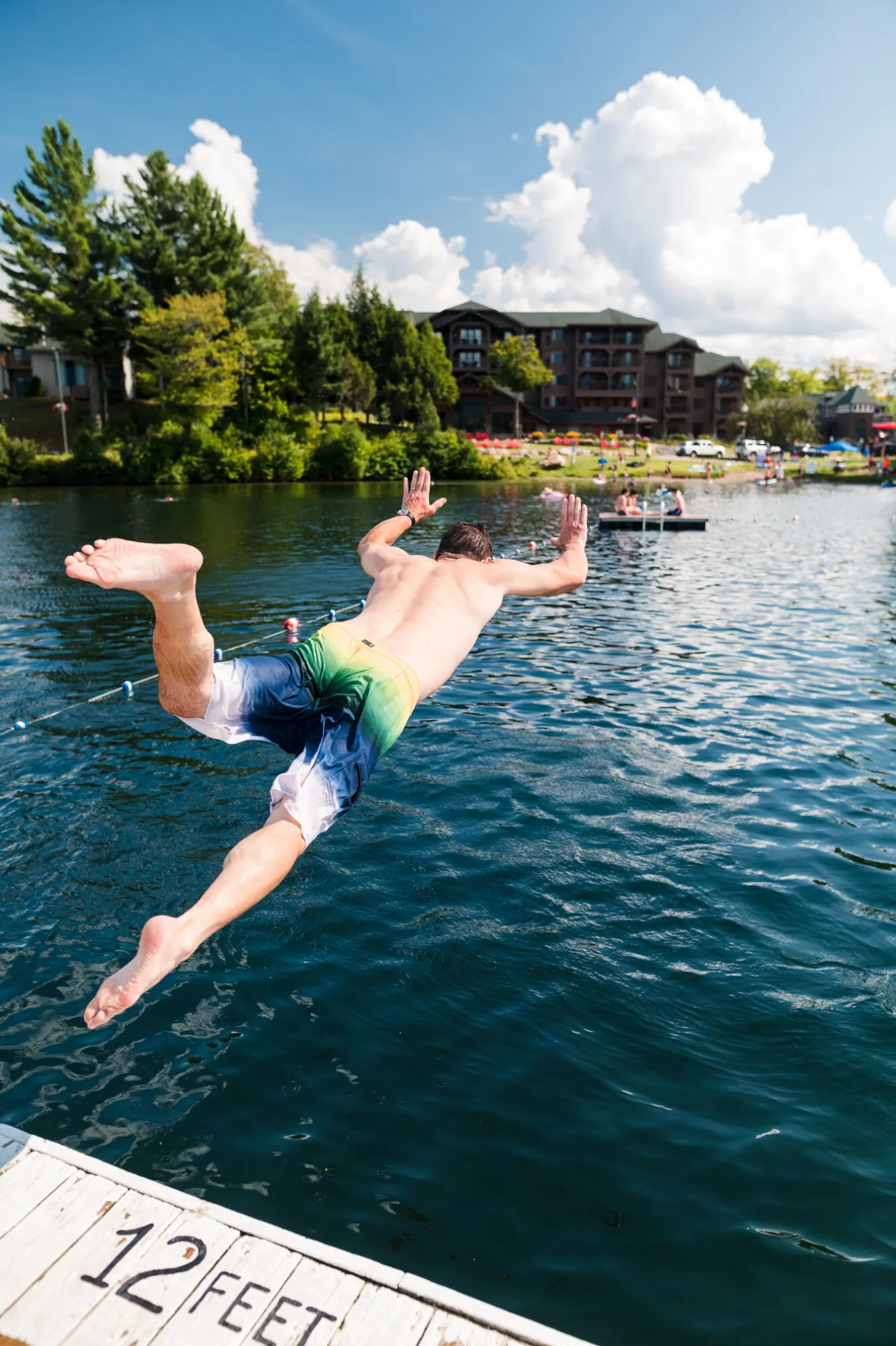 A man jumps into a lake. 