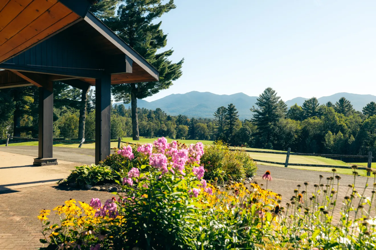Flowers at the exterior of a golf club entrance on a sunny summer day.