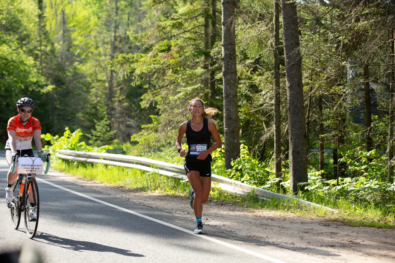 A woman runs on a spring road. 