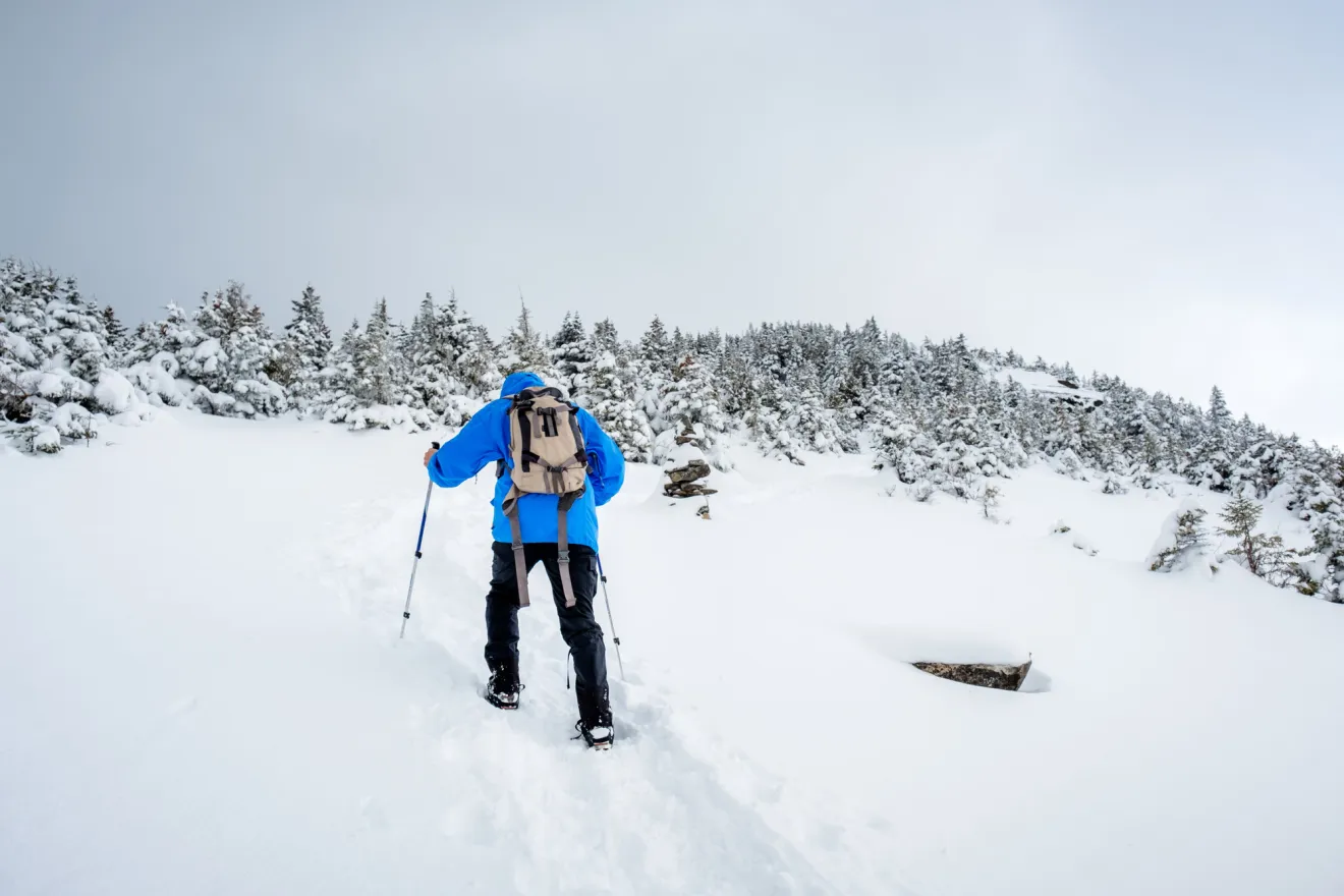 A person snowshoeing through thick snow.