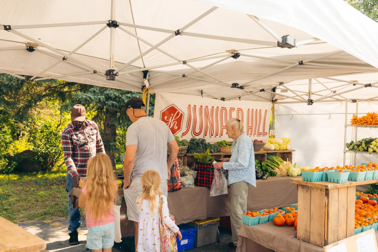 A family buying vegetables at a farmers market